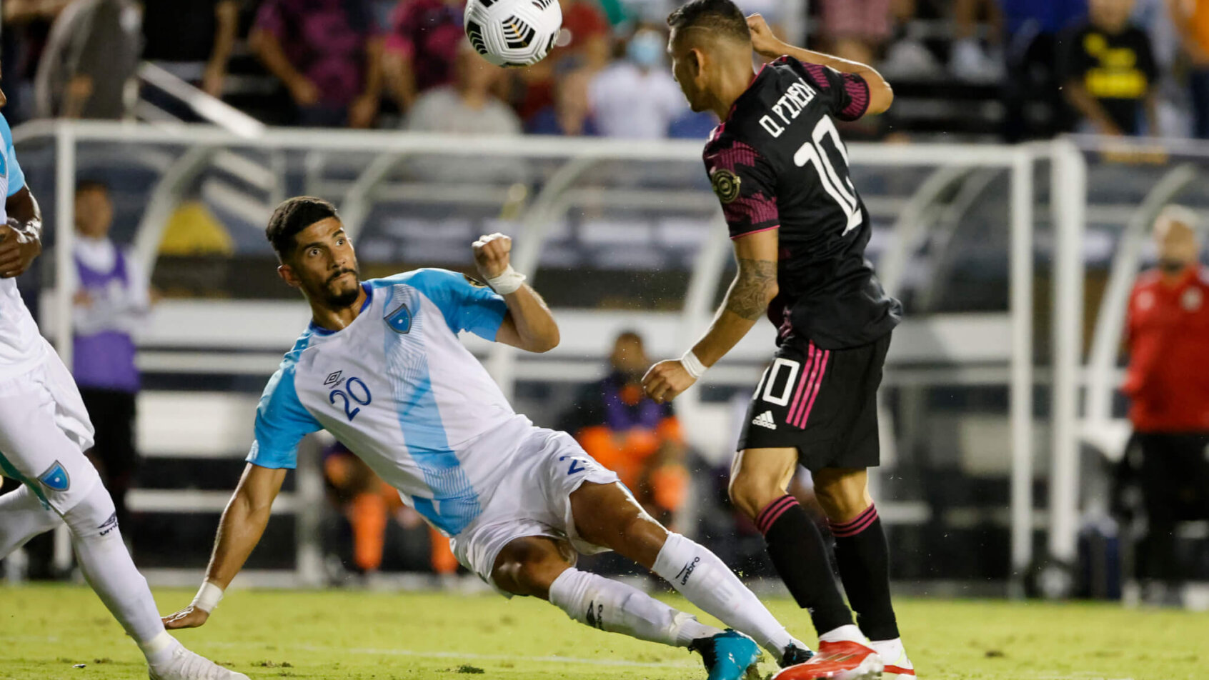 Guatemala defender Gerardo Gordillo defending against Mexico midfielder Orbelin Pineda during a COCACAF Gold Cup Soccer Match.