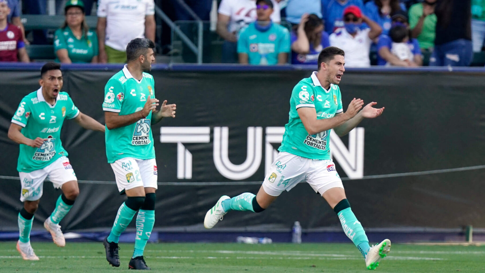 Jose Godinez of Leon celebrating with teammates after scoring a goal.