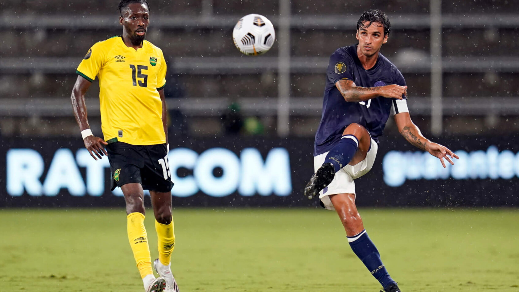 Costa Rica midfielder Bryan Ruiz clearing the ball away from the opposing team players.