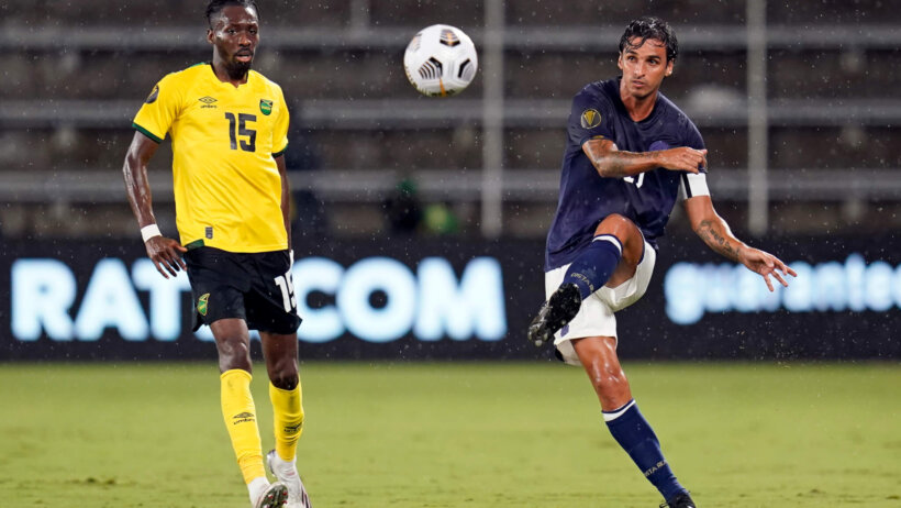 Costa Rica midfielder Bryan Ruiz clearing the ball away from the opposing team players.
