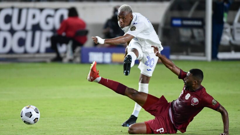 Deybi Flores kicks ball past sliding defender