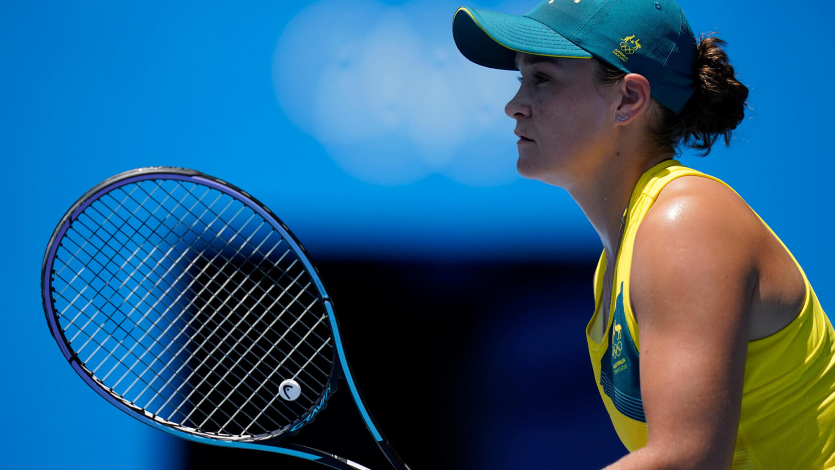 Ashleigh Barty reading for a serve from an opponent during a match.