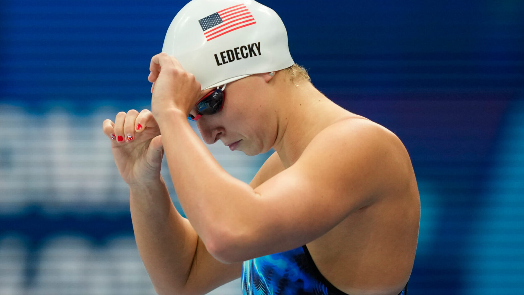 Katie Ledecky adjusts her swim cap