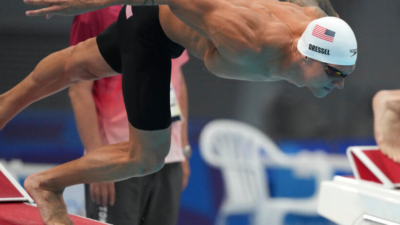Caeleb Dressel dives into the pool