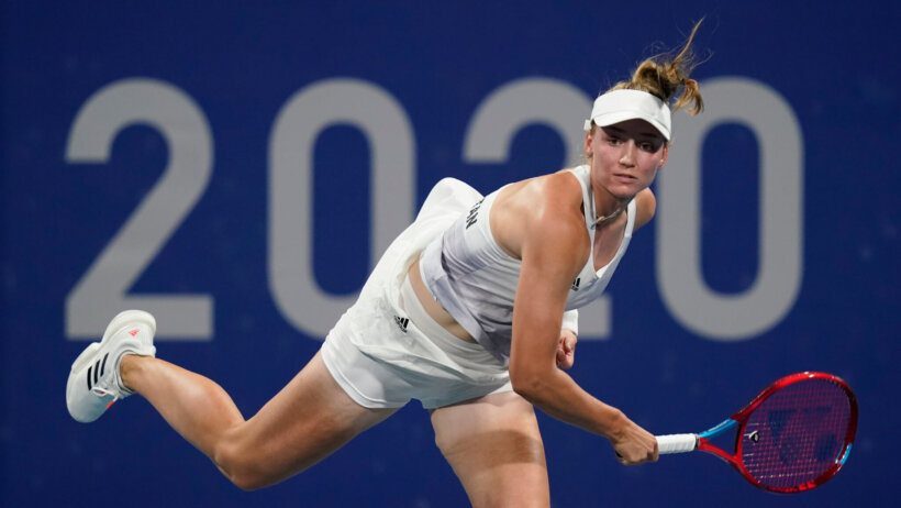 Elena Rybakina serving the ball during a tennis match at the Olympics.