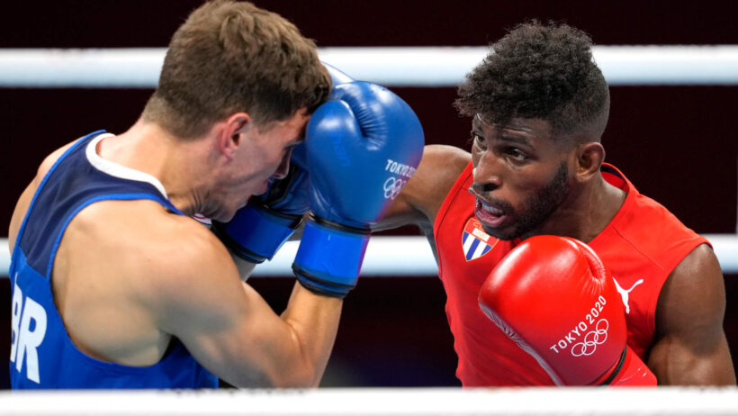 Cuba's Andy Cruz punching Britain's Luke McCormack during a boxing match at the Olympics.