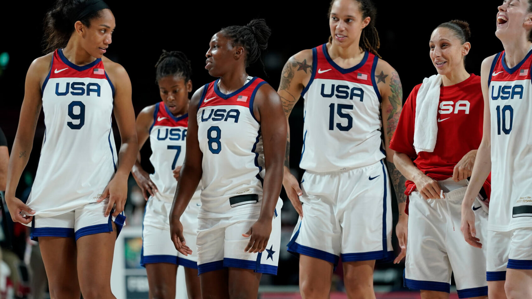 USA Women's Basketball players walking off the court after a win during the Olympics.