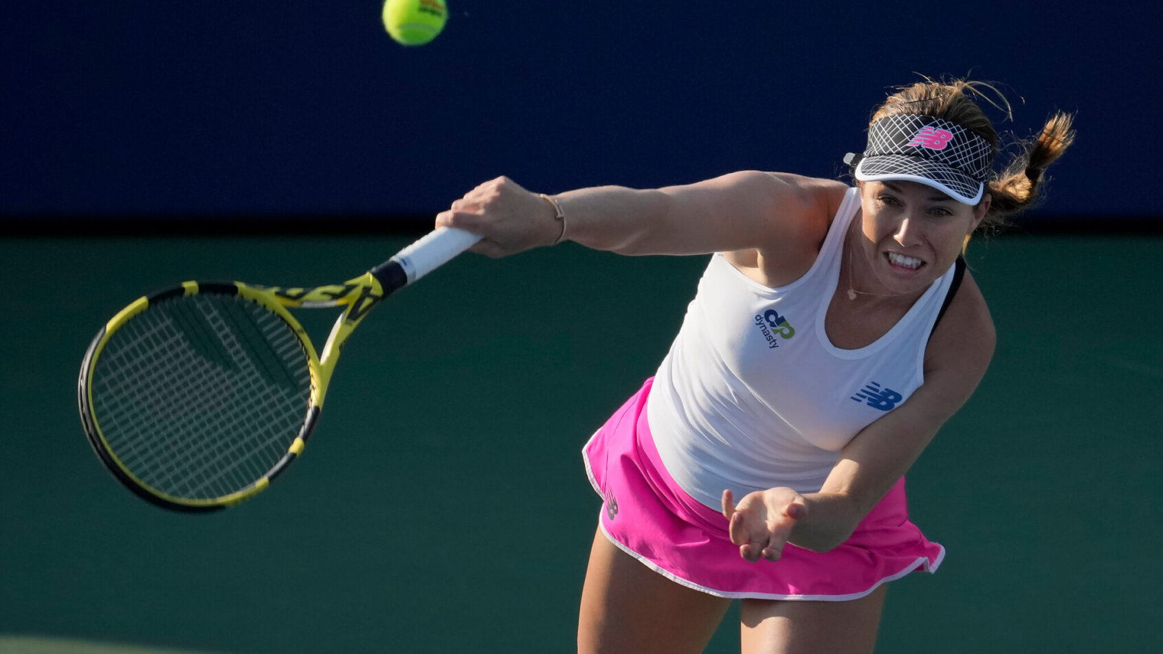 Danielle Collins hitting a return to her opponent during a tennis match.