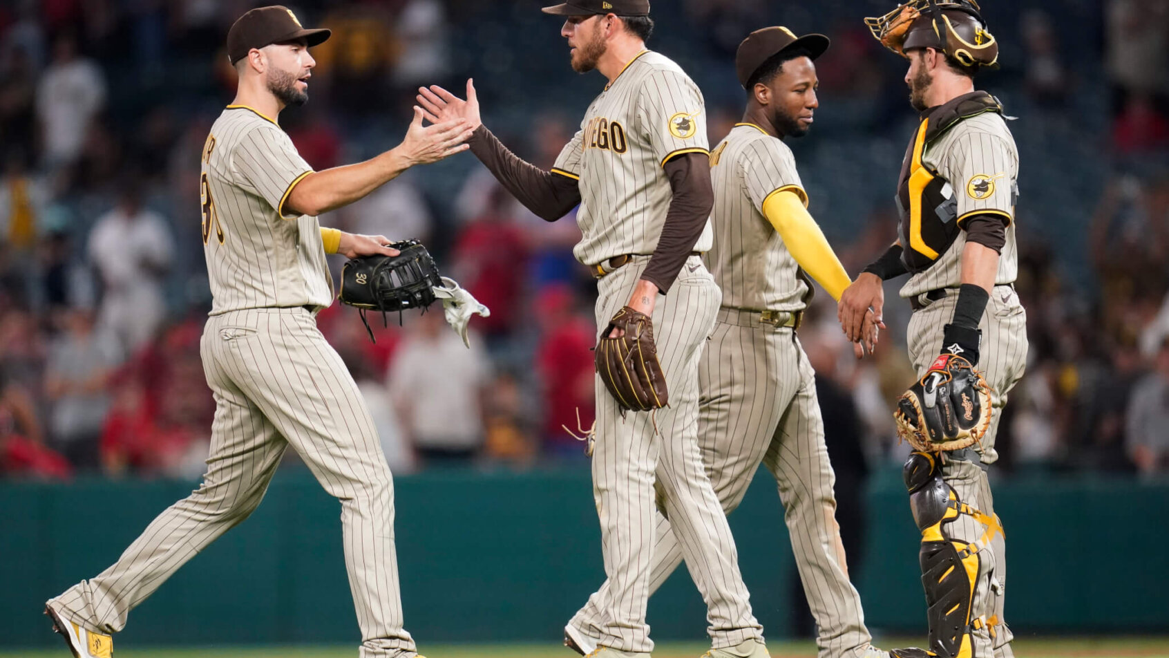 San Diego Padres players celebrating a win on the field.