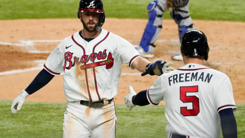 Atlanta Braves' Dansby Swanson celebrates with Freddie Freeman