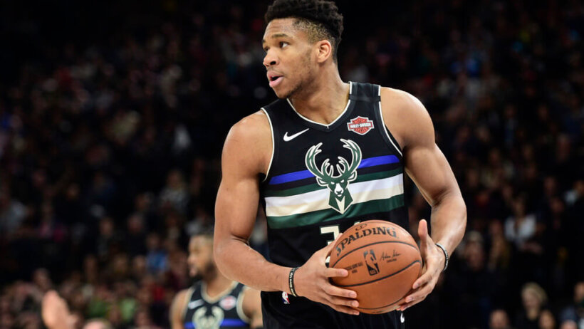 Giannis Antetokounmpo holding ball at stomach