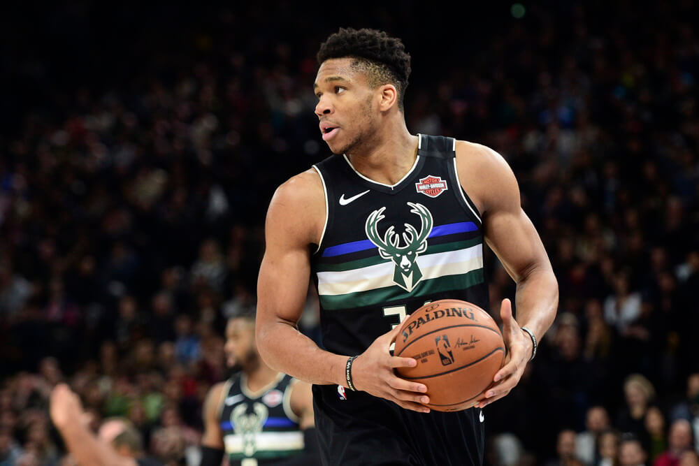 Giannis Antetokounmpo holding ball at stomach