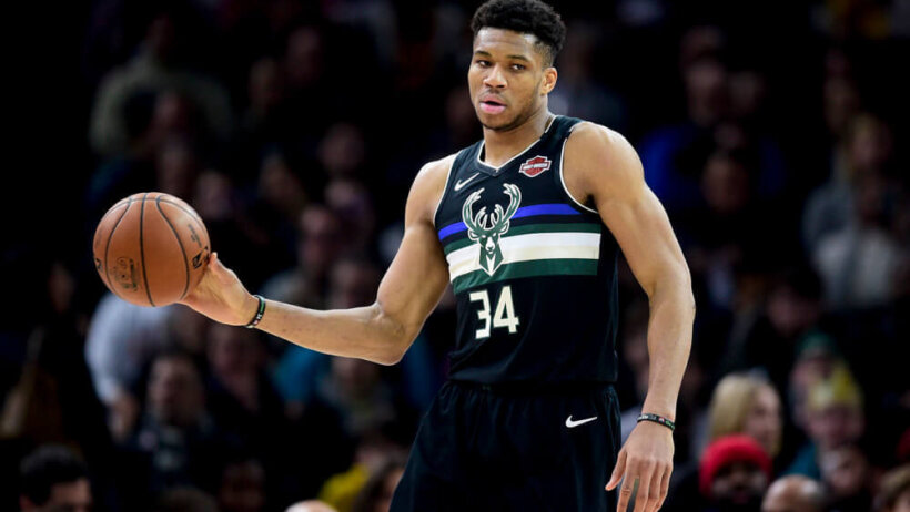 Giannis Antetokounmpo dribbles up court