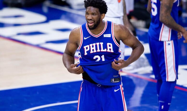 Joel Embiid pulling on bottom of jersey