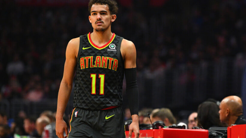 Trae Young standing at scorers table
