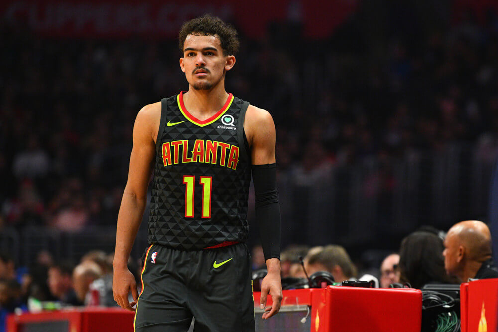 Trae Young standing at scorers table