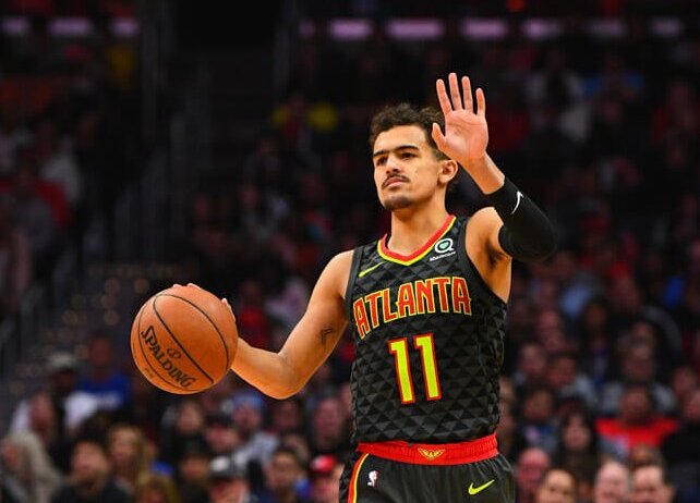 Trae Young dribbling with lift hand up