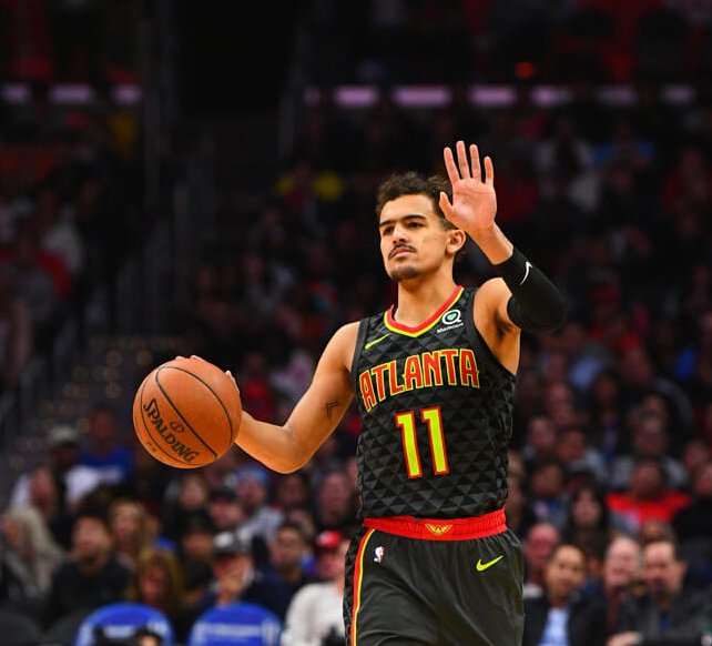 Trae Young dribbling with lift hand up