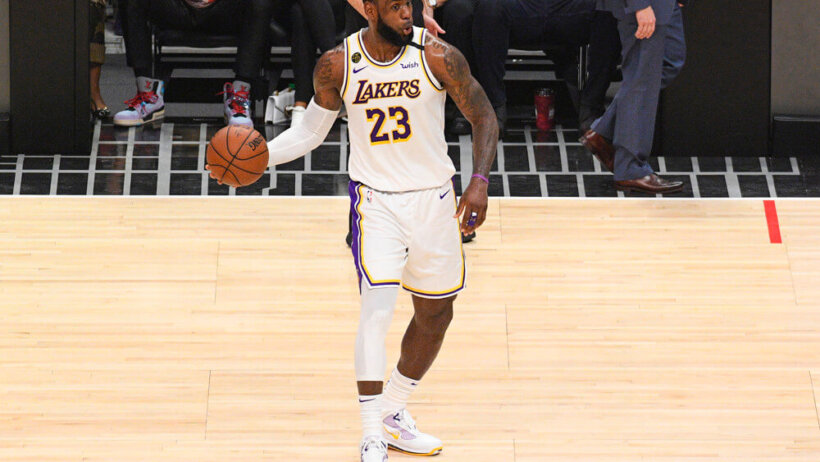 LeBron James holding ball with right hand looking to pass