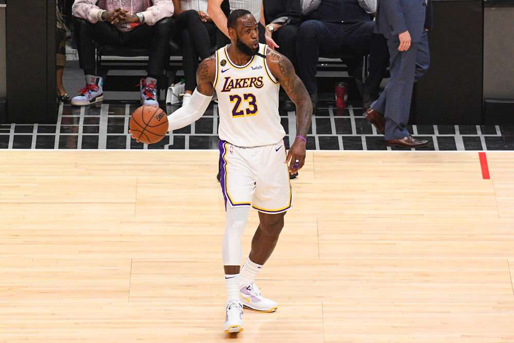 LeBron James holding ball with right hand looking to pass