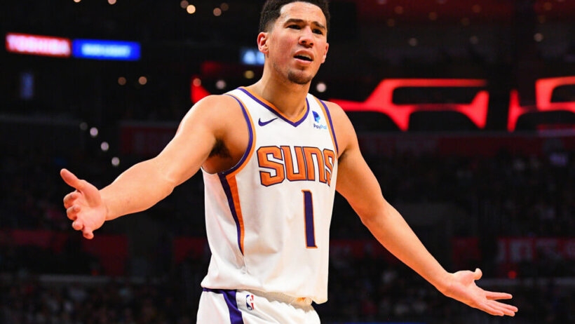 Devin Booker arms out looking at someone