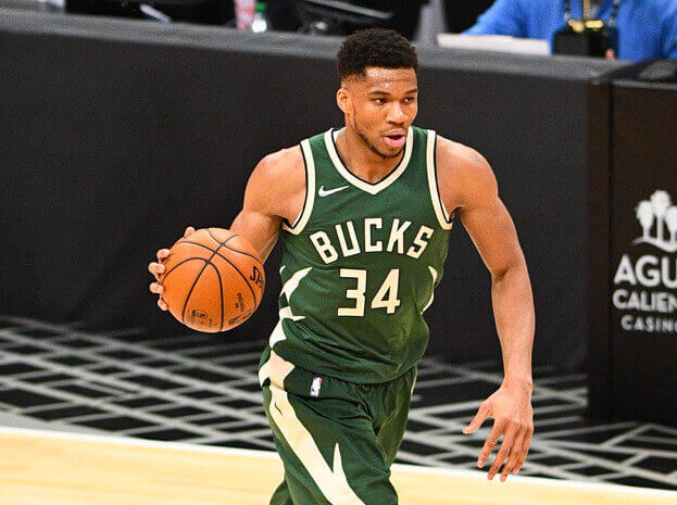 Giannis Antetokounmpo dribbles up court