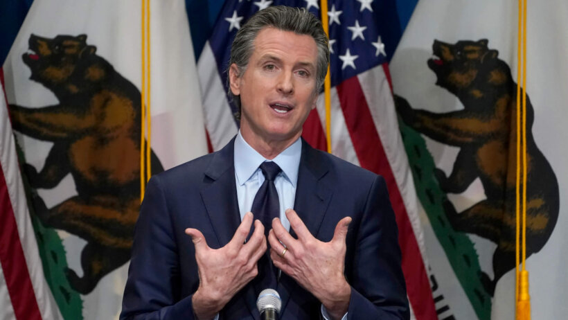 California Gov. Gavin Newsom speaking at a podium