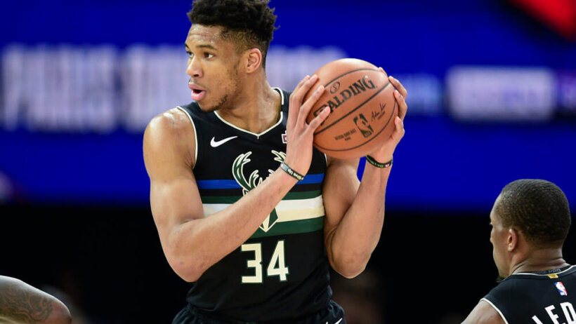 Giannis Antetokounmpo handling the ball during a NBA game.