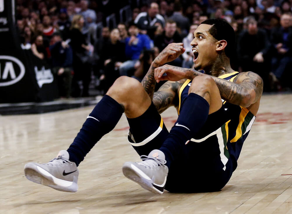 Jordan Clarkson on the court seated and yelling