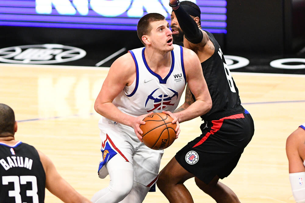 Nikola Jokic moving past defender in paint