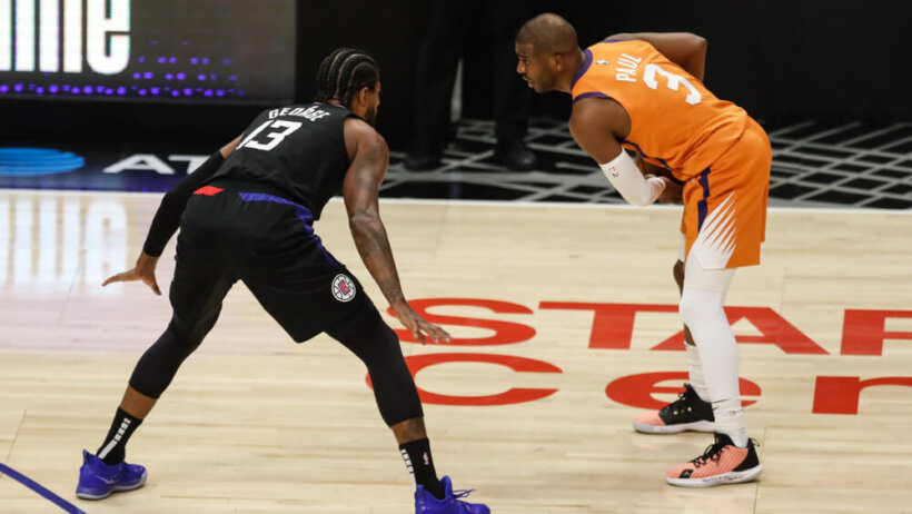 Paul George defending Chris Paul during a NBA playoff game.