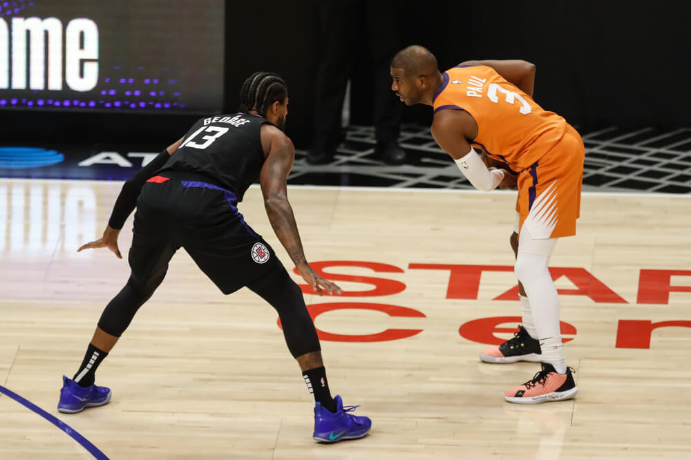 Paul George defending Chris Paul during a NBA playoff game.