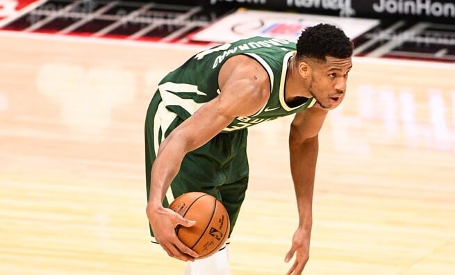 Giannis Antetokounmpo dribbling at top of key
