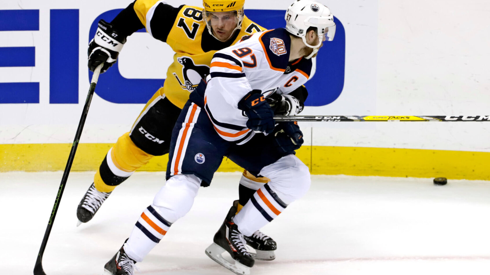 Sidney Crosby grabbing onto Connor McDavid