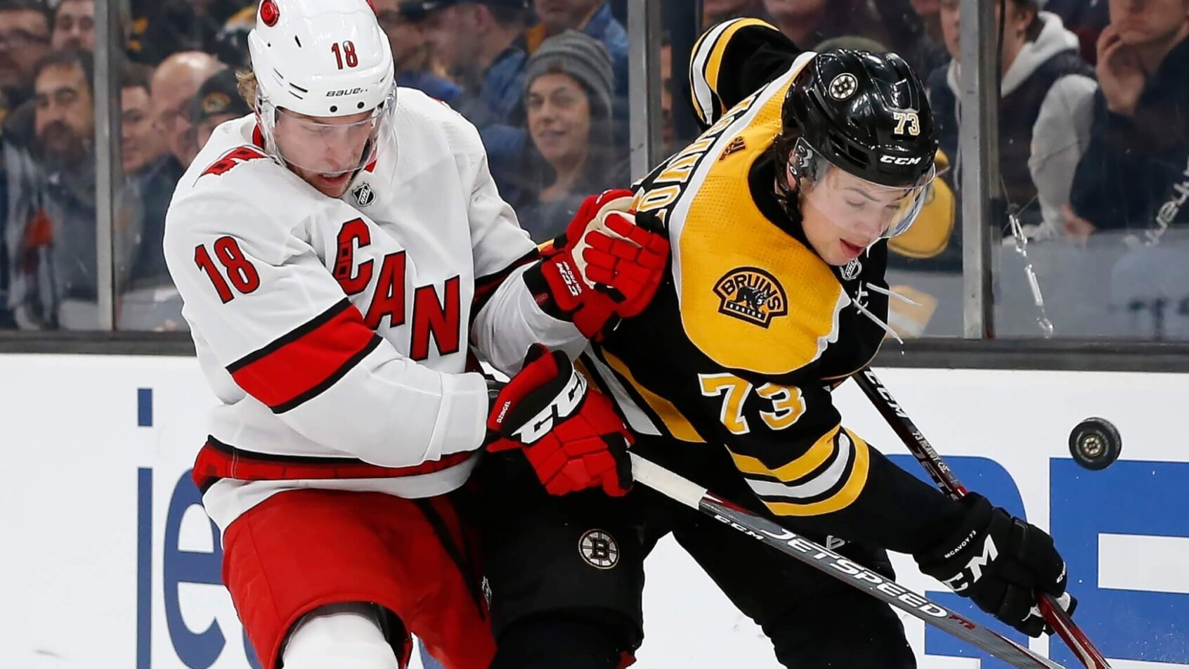 Ryan Dzingel, Charlie McAvoy battle along boards