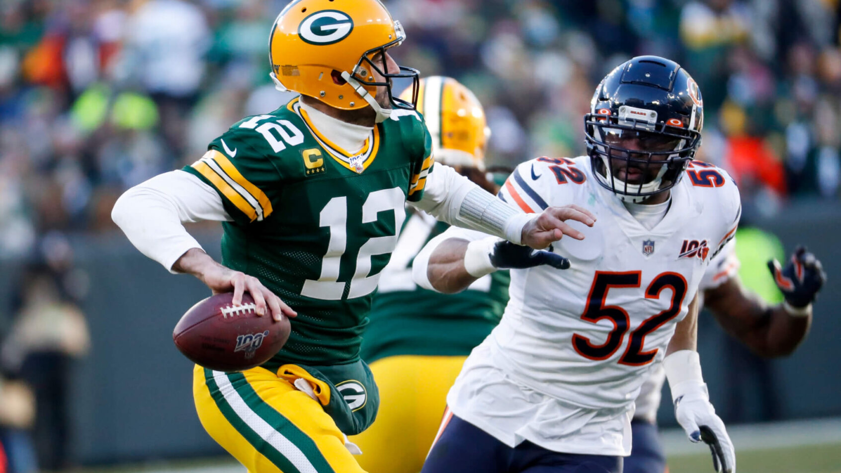 Aaron Rodgers chased by Khalil Mack