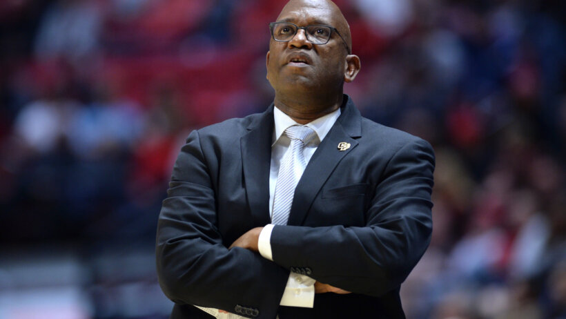 John Smith watches his team