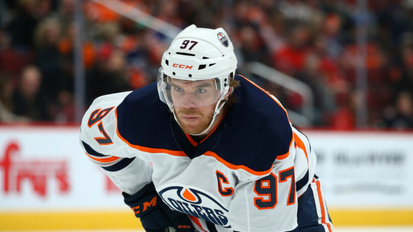 Edmonton Oilers center Conner McDavid watching the puck during an NHL game.