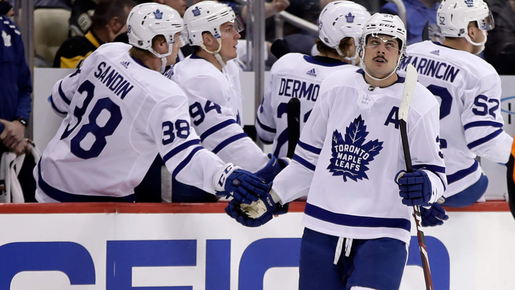 Auston Matthews skating past team bench