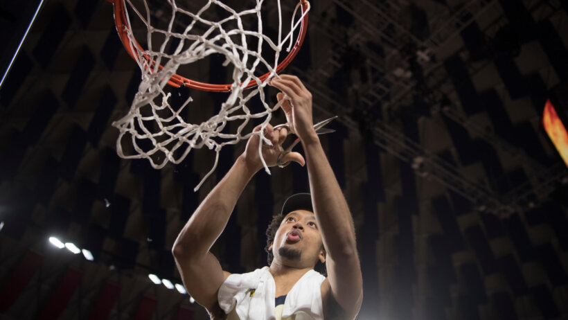 Liberty guard Darius McGhee cutting the nets after the A-Sun title game in 2020