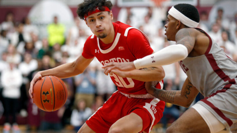 Boston University's Javante McCoy driving past a defender