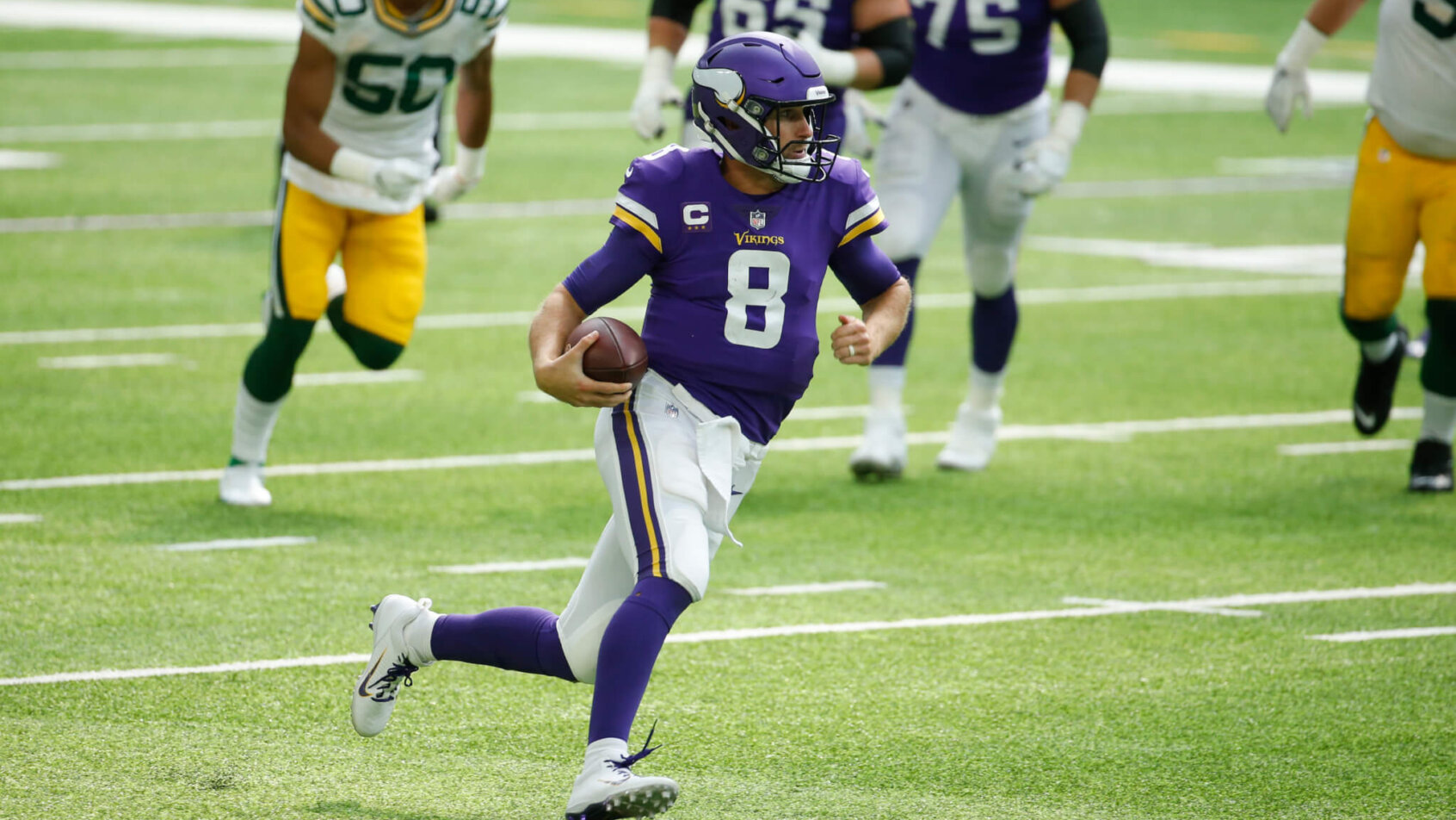 Kirk Cousins running with football