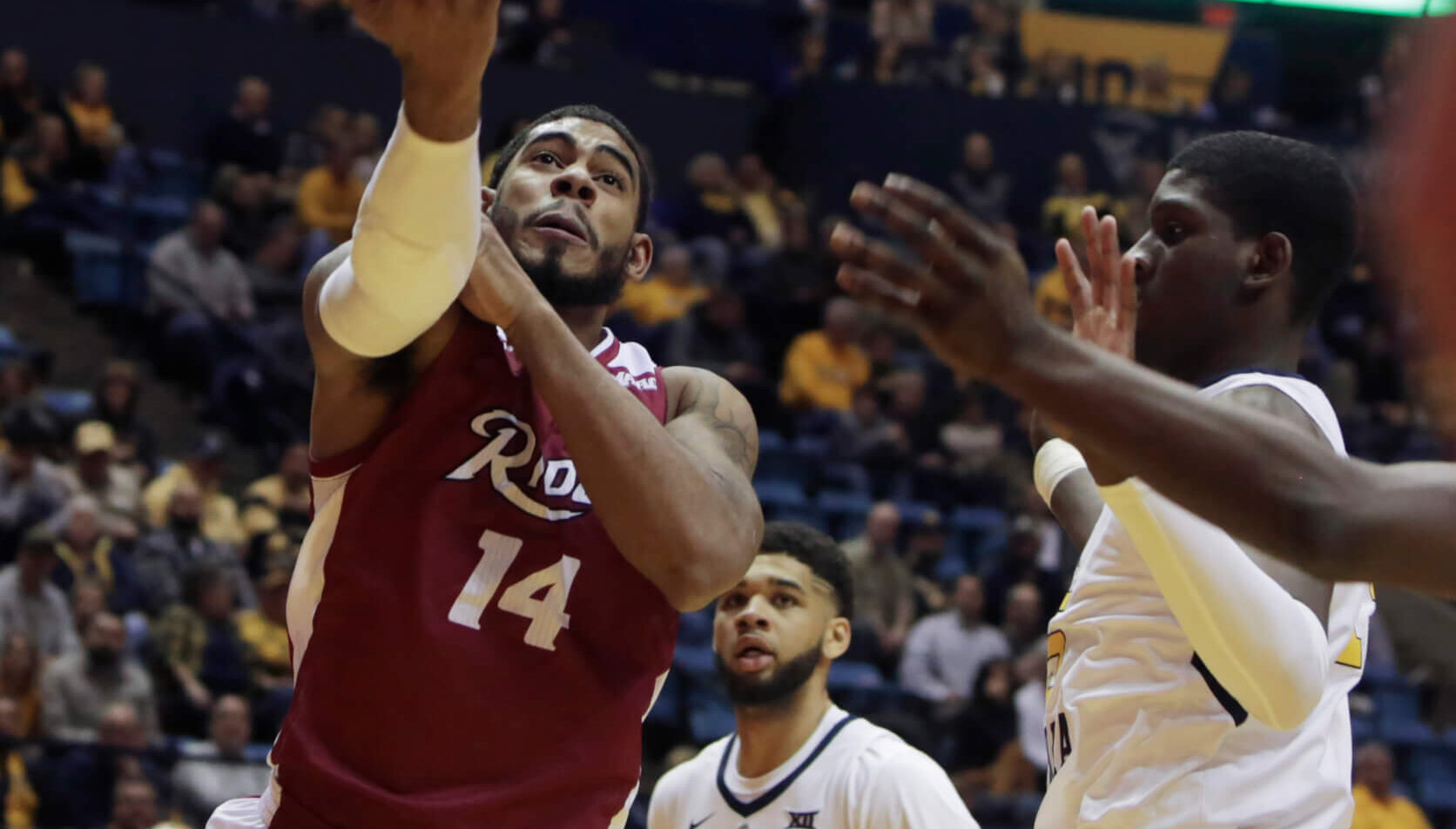 Rider guard Dimencio Vaughn driving to the hoop