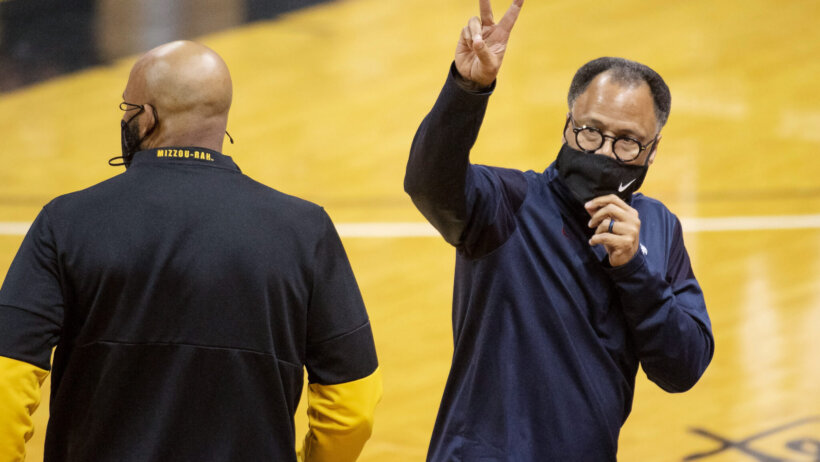 Liberty coach Ritchie McKay waving