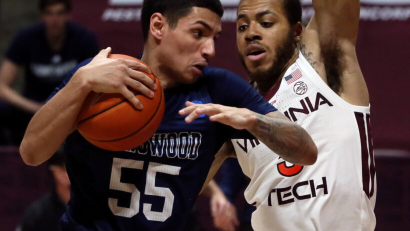 Longwood's Juan Munoz trying to force his way past a Virginia Tech defender