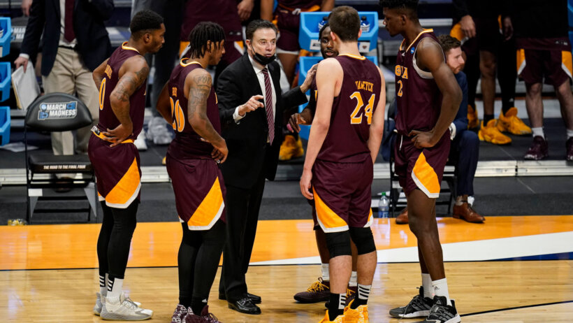 Iona head coach Rick Pitino huddles with his players
