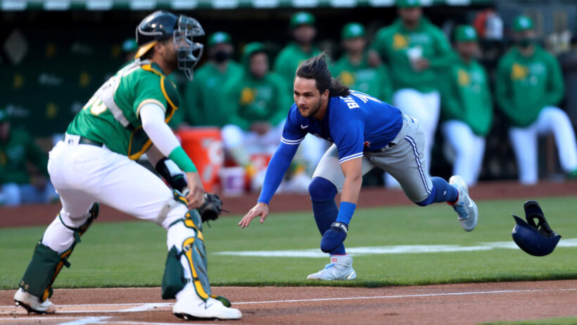 Toronto Blue Jays' Bo Bichette diving into home plate