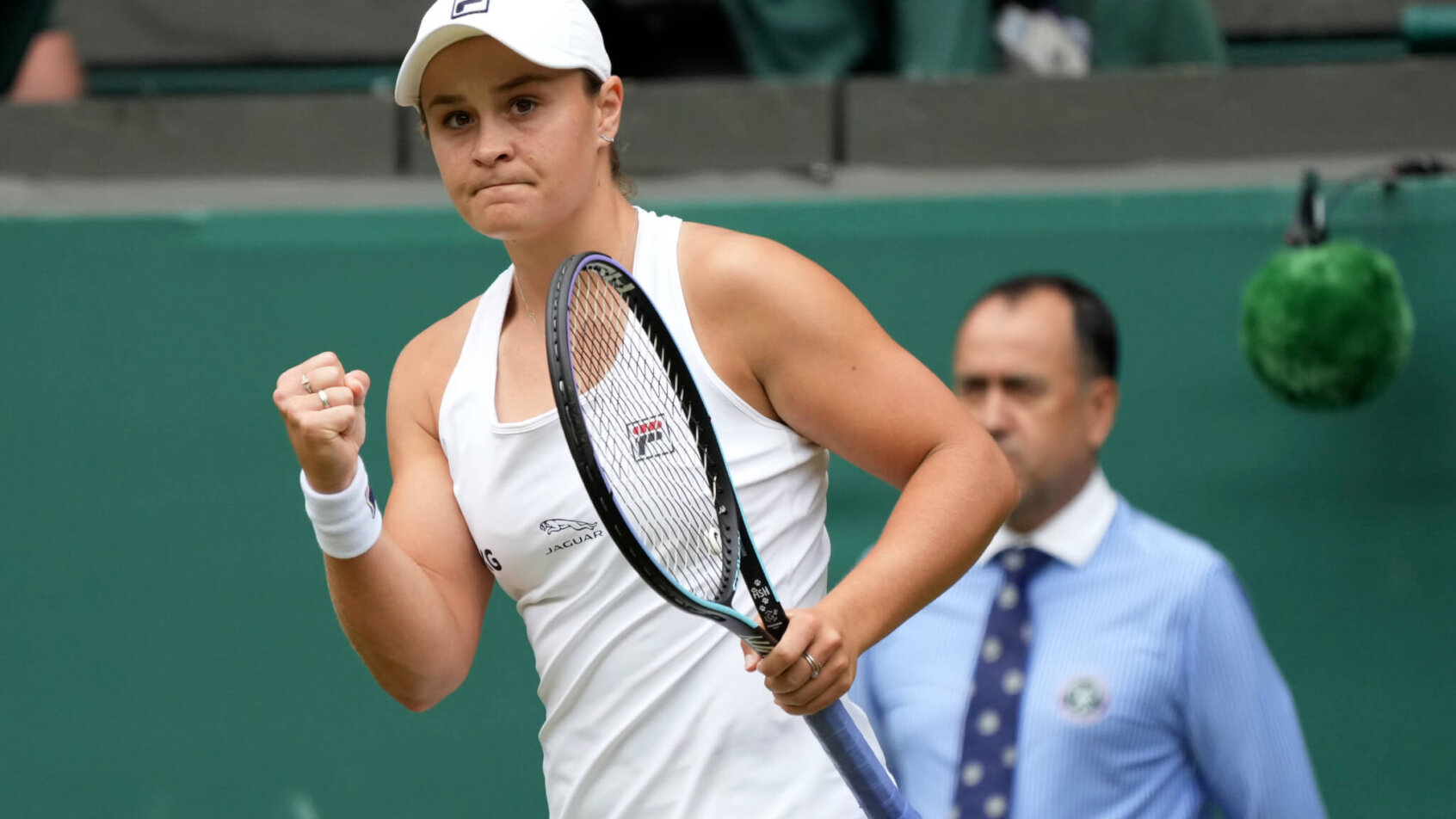 Ashleigh Barty celebrating with a fist pump after a tennis match.