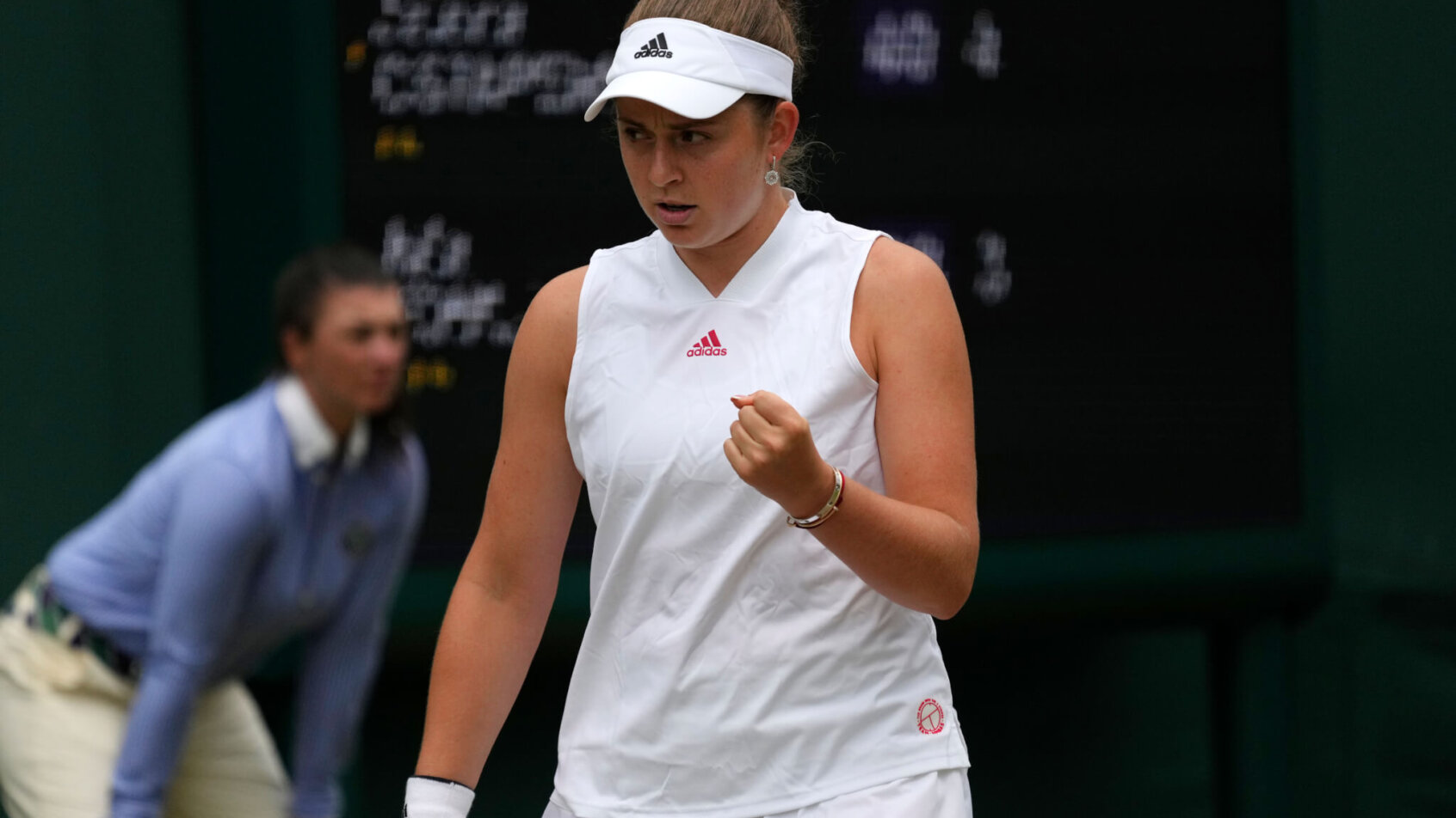 Jelena Ostapenko celebrating with a fist pump after winning a point during a match.