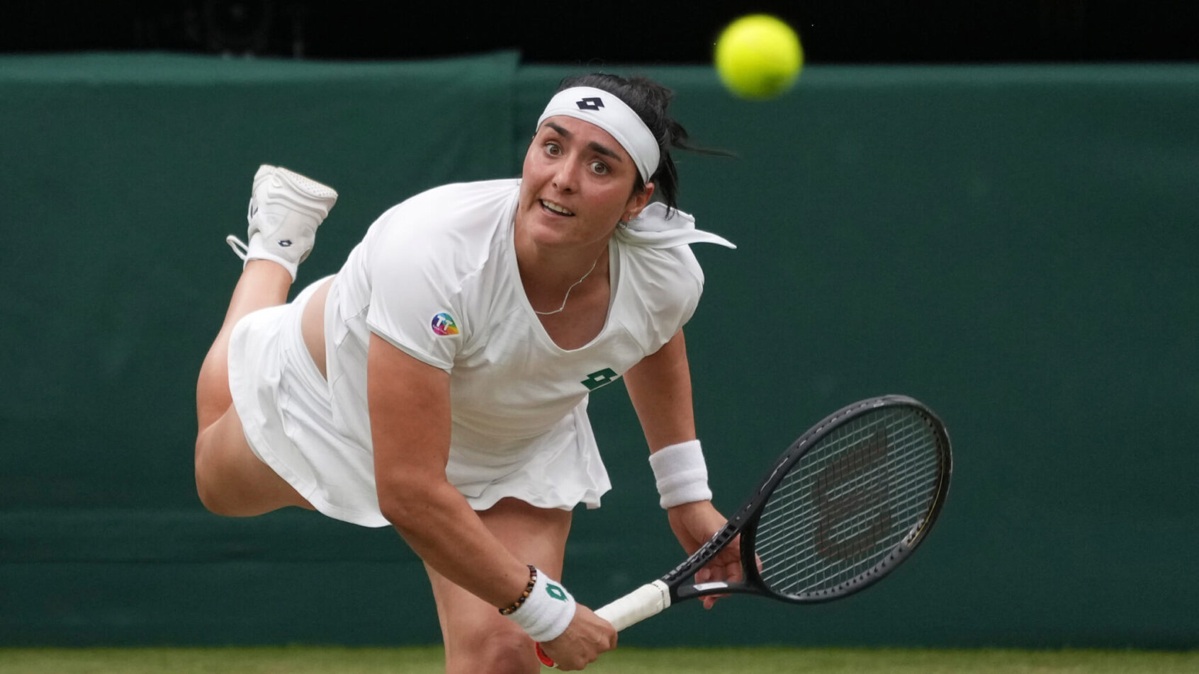 Ons Jabeur hitting a return to her opponent during a tennis match.